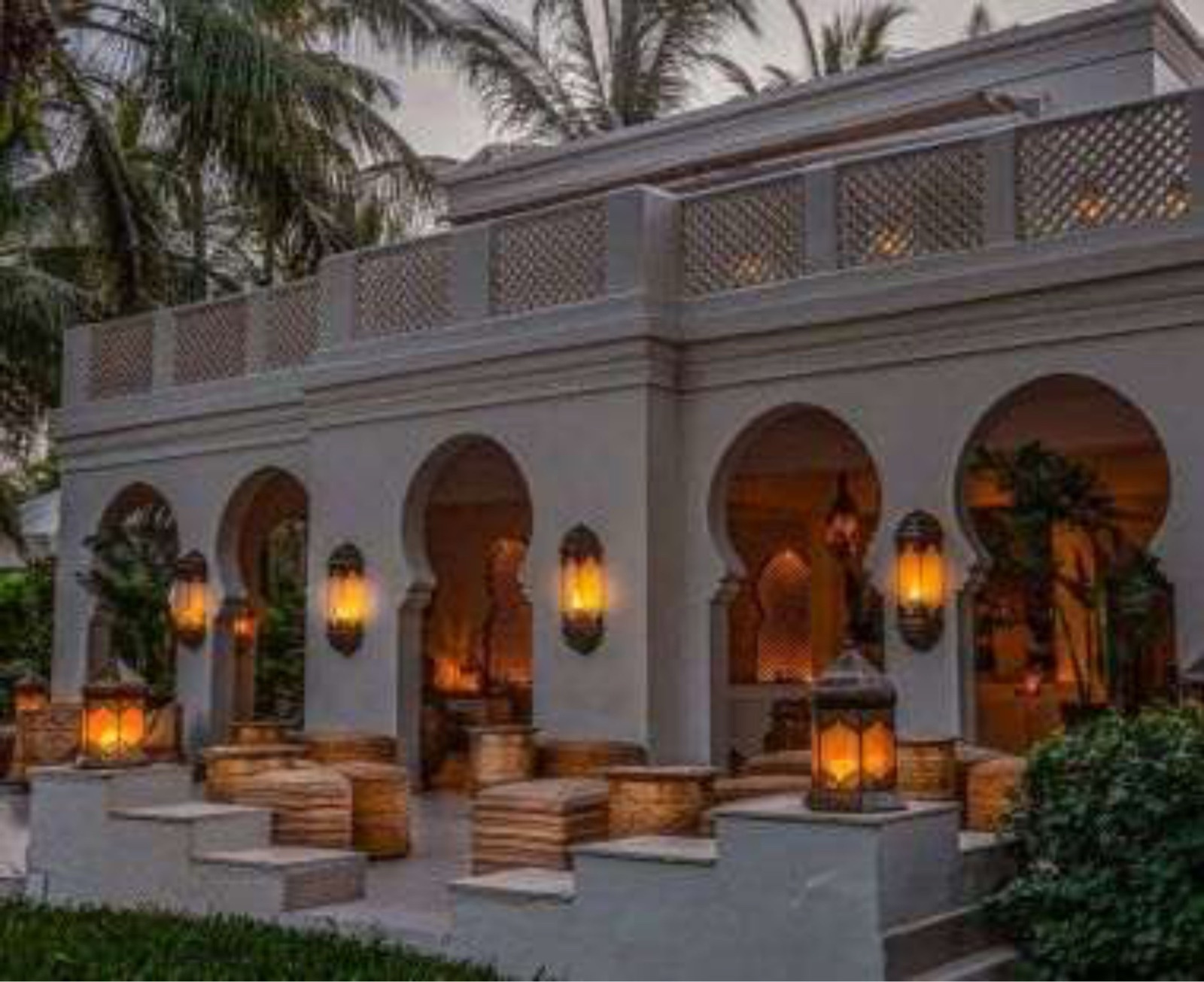 Pergola d'hôtel avec lanternes accrochées sous arches mauresques